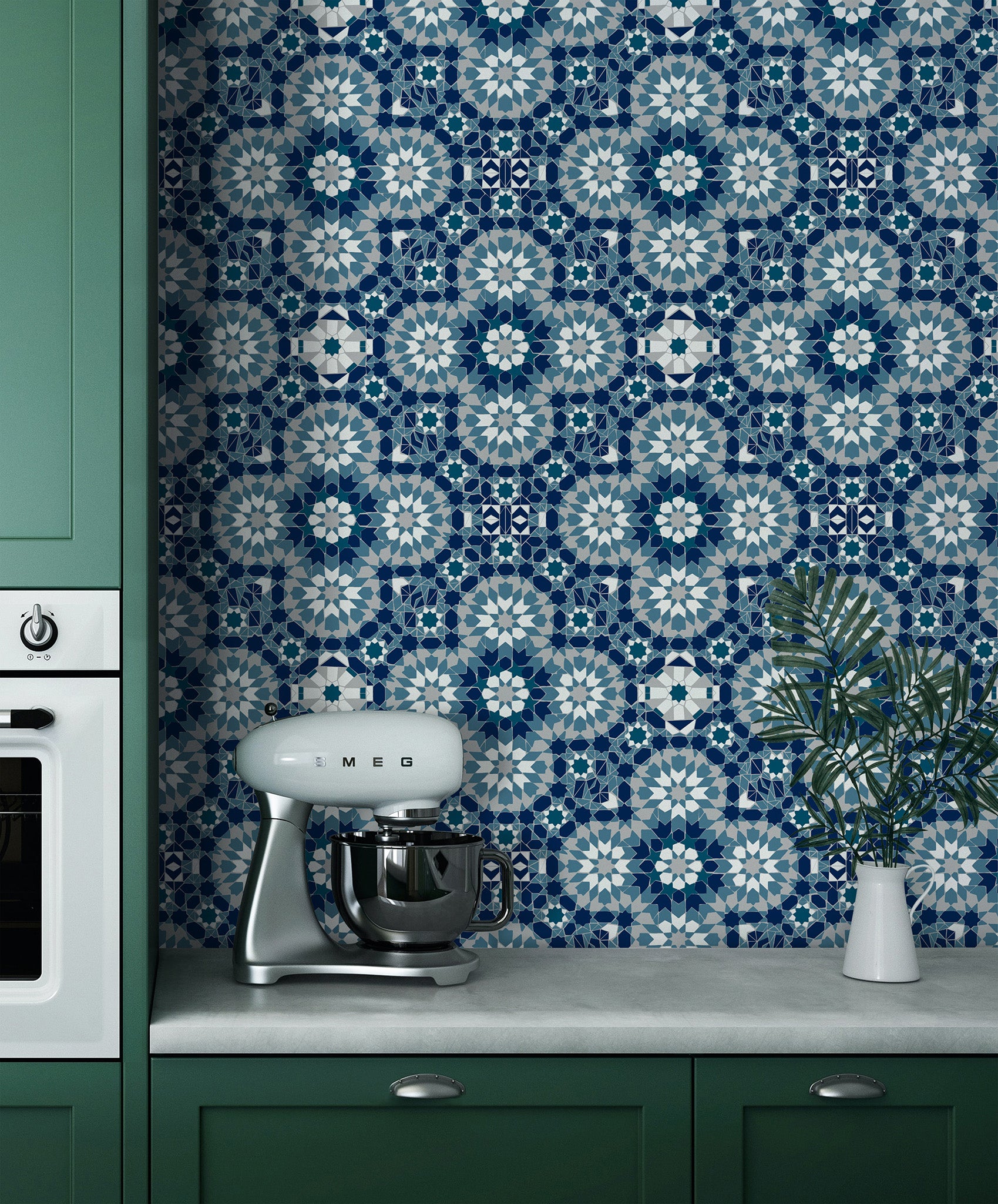 Kitchen with green cabinets, blue patterned wall, and Smeg mixer.